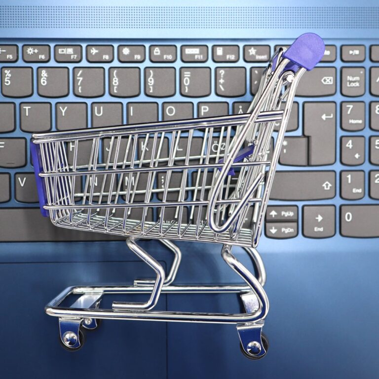 mini shopping cart on laptop keyboard e commerce concept