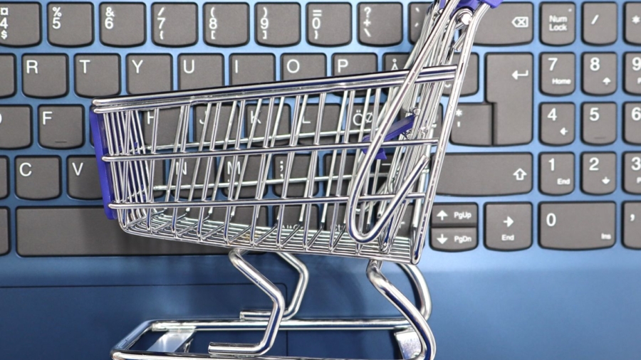 mini shopping cart on laptop keyboard e commerce concept